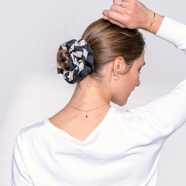 Pet accessories | Scrunchie | Dogily Woman using Dogily Serene Scrunchie in Black Stripes on a hair bun